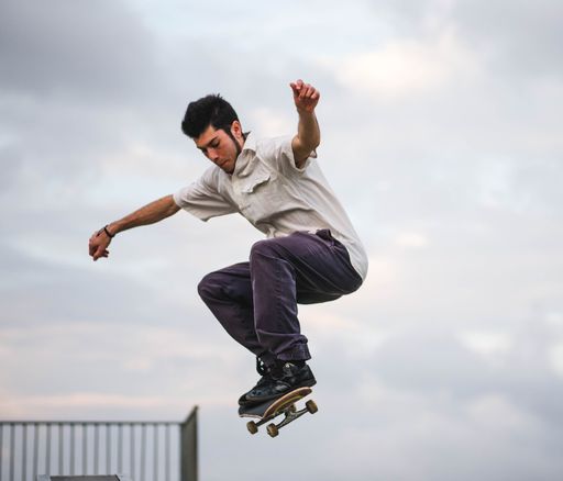 A mesmerizing shot of a young attractive skateboarder doing jump trick