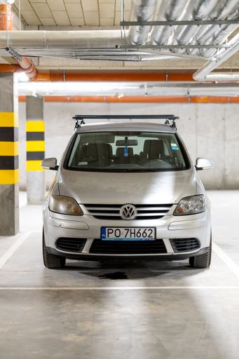 A parked Volkswagen Golf Plus car from the front in a parking garage