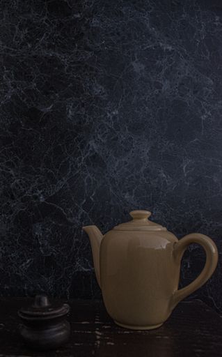 A beautiful porcelain brown teapot on the table