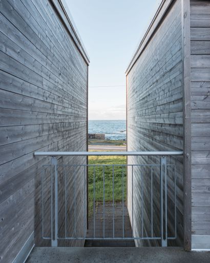 A vertical shot of a gate between two wooden buildings