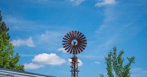 A low angle shot of an old windmill in the countryside