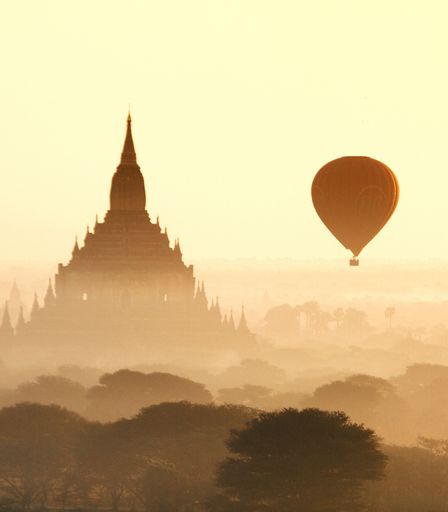 The scenic view of a balloon flying at the old Bagan temples of Myanmar