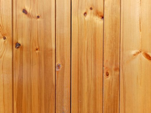A closeup of a wall made of wooden planks with detailed wood grain