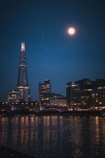 A London skyline background with illuminated buildings and The Shard at night