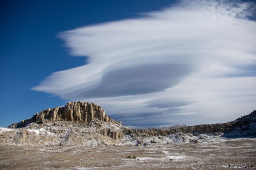 The huge rock formation against a cloudy sky in the Bucegi Natural Park in Romania