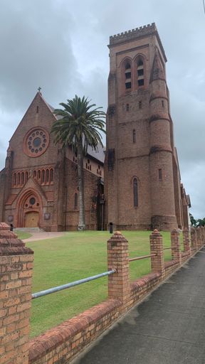 A vertical shot of St Carthage's cathedral with a beautiful yard under a cloudy sky