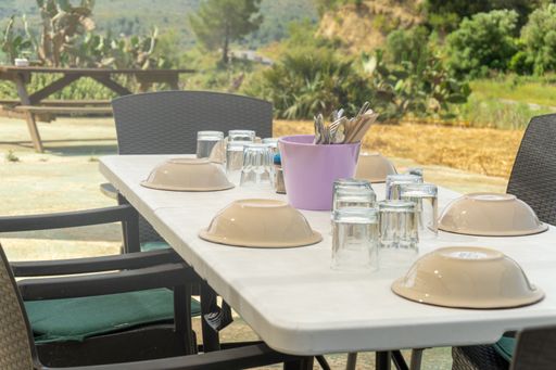 The high-angle view of an outdoors restaurant table with setting