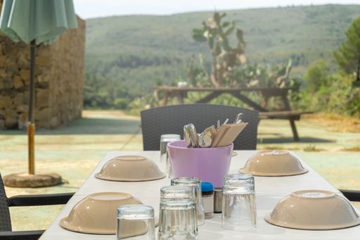 The high-angle view of an outdoors restaurant table with setting
