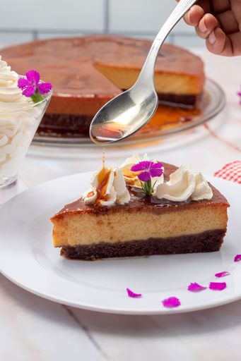 A vertical shot of a chocolate and flan dessert, inverted cake with chocolate sponge cake and milk flan