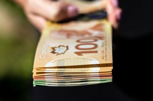 The closeup of Canadian cash in the hands