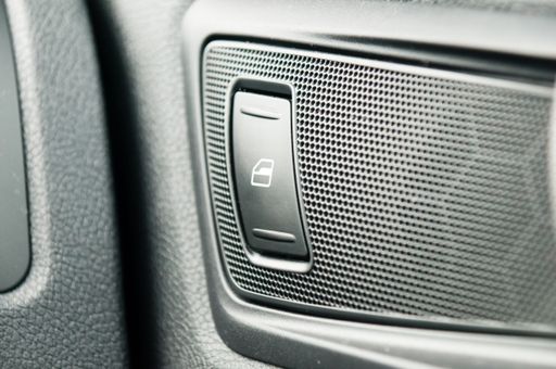 A closeup shot of a gray window switch button in a car