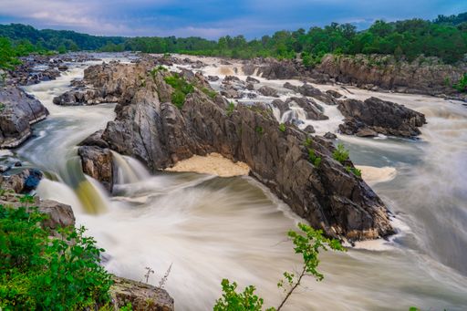 The beautiful view of the Potomac river flowing through the stones, Great Falls, USA, long exposure
