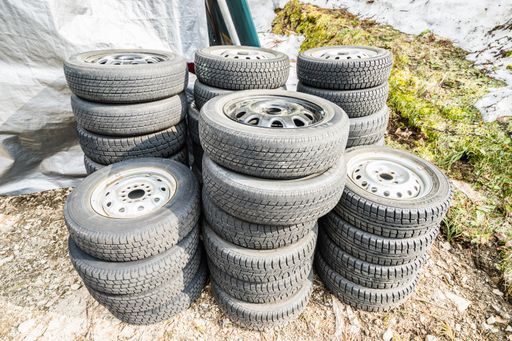 A high angle shot of stacks of gray dirty tires