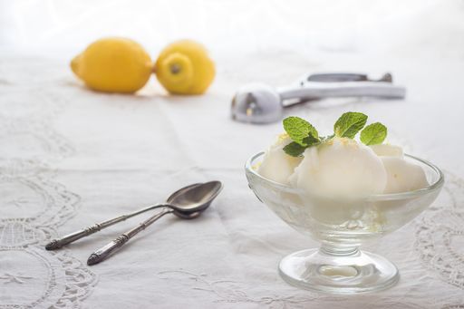A selective focus shot of vanilla ice cream with mint leaves in a bowl