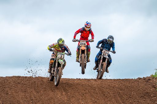 The racers on motocross along the dirt road at the "Donkey of the road" at Latvian National Motocross Cup in Dobele