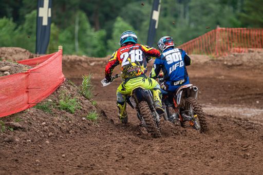 Competitive motorbikers riding during Latvian National Motocross Cup on a soil ground