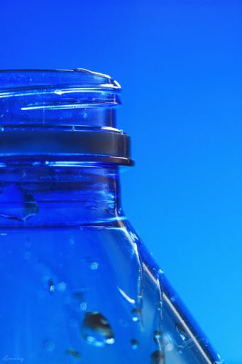 A closeup shot of a plastic bottle on blue background