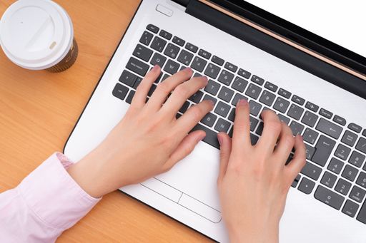 A person working on the computer remotely due to Covid-19 pandemic quarantine