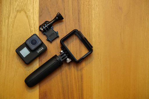 A top view of Gopro 7 black assorted accessories on a wooden background