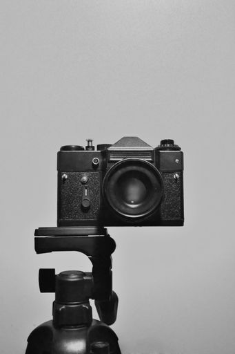 A closeup of 35mm slr camera on the tripod