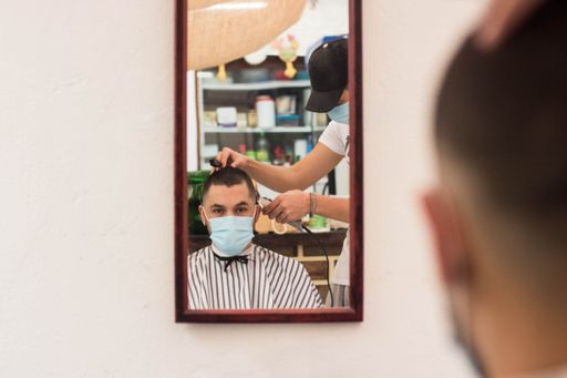 A closeup shot of a young male getting a new stylish haircut in the barbershop