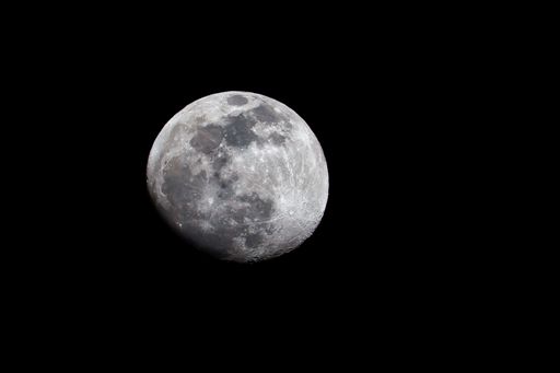 A bright moon in the sky during night time