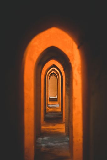 A vertical shot of the arches in The Royal Alcazars of Seville, located in Seville, Spain