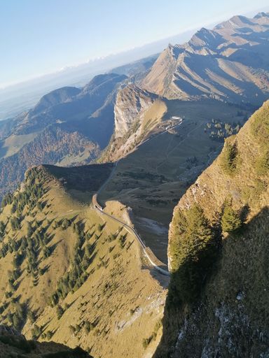 A vertical aerial view of the Rochers de Naye against a clear blue sky