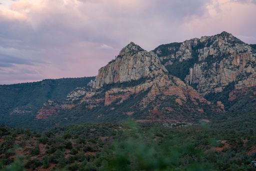 Sedona landscape of beautiful cliffs and vibrant clouds during warm summer sunset
