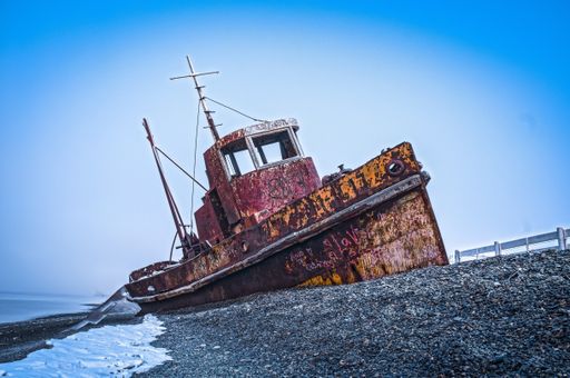 An old abandoned and rusted boat on the seashore