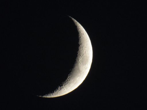 A breathtaking view of the crescent moon in the black sky