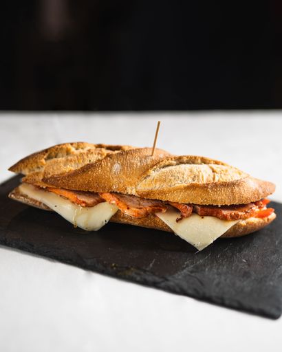 A closeup shot of a delicious freshly made sandwich on a black board