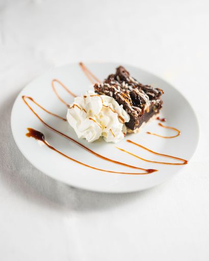 A closeup shot of a brownie with ice cream