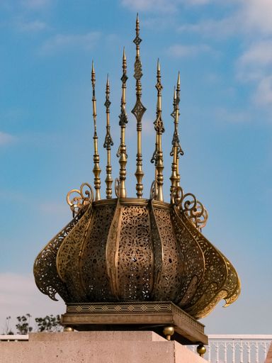 A vertical shot of the golden decorations with the emblem of Morocco, Tour Hassan, Rabat, Morocco
