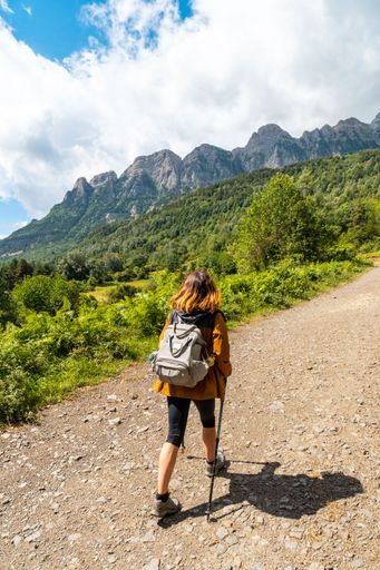 A young woman trekking to the Piedrafita arch in the Pyrenees in Panticosa, Aragon