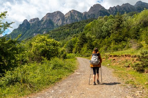 A young woman trekking to the Piedrafita arch in the Pyrenees in Panticosa, Aragon