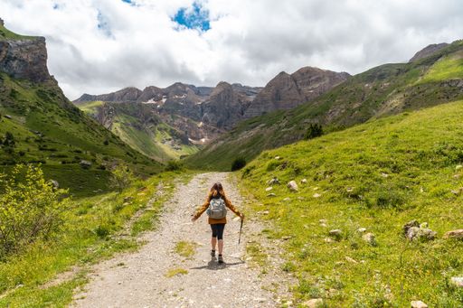 A female hiker with a backpack on the trek in the valley