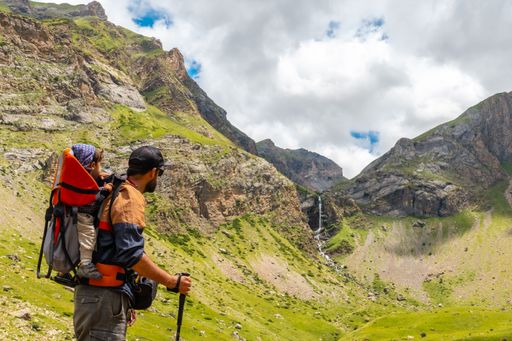 A young man visiting the waterfall in the valley