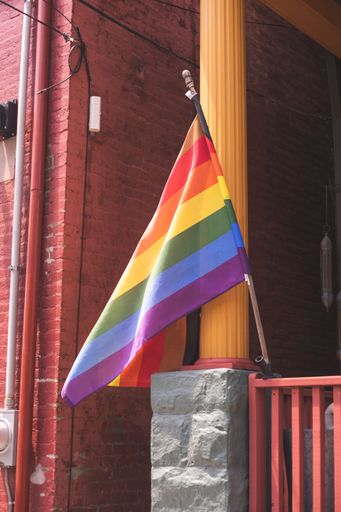 A rainbow flag on a balcony of a building