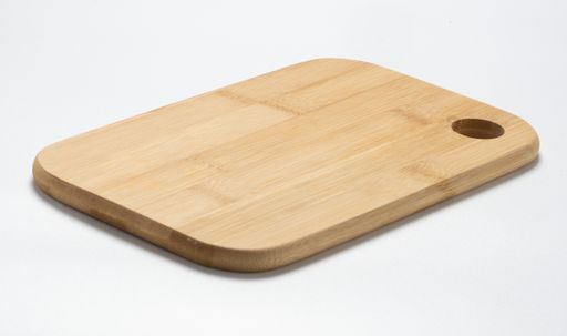 A wooden chopping board with a hole on it isolated on the white background