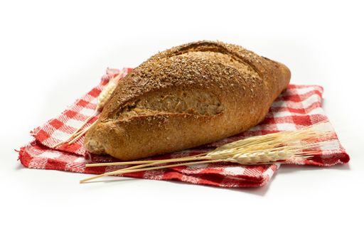 A fresh baked bread on the red checkered towel isolated on white background