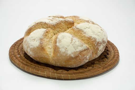 A closeup shot of a freshly baked bread placed on a wooden board - perfect for background