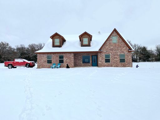 A snow covered building surrounded by trees