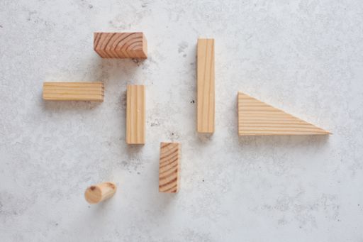 A top view of different Wooden set pieces on a white surface, kids education