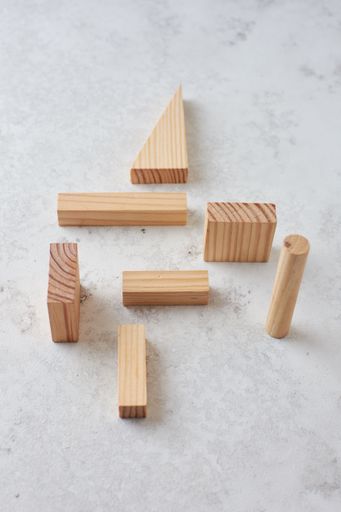 A top view of different Wooden set pieces on a white surface, skills building concept