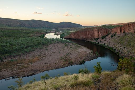 A beautiful shot of a curved river and a mountain landscape during sunset