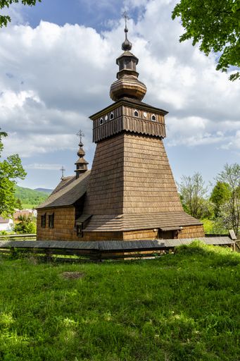 The image shows an old wooden church of the typical architecture  of the older churches in this area of Slovakia