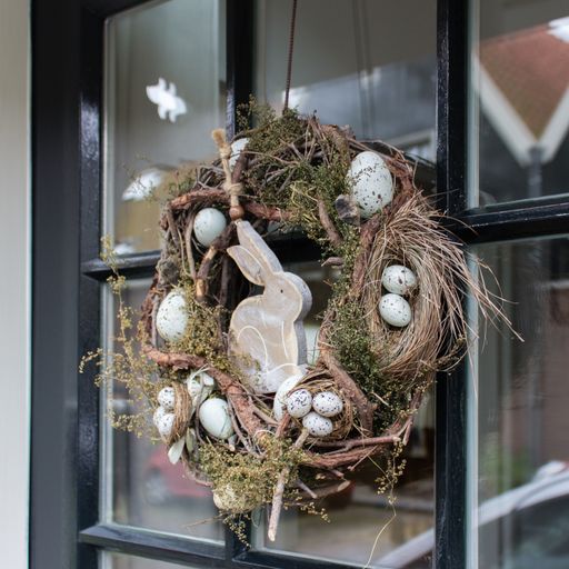 A closeup shot of a traditional Easter eggs on the entry glass door