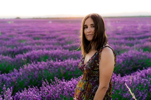 A beautiful female walking on a lavender field captured in Brihuega, Spain