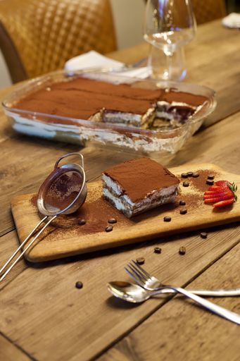 A piece of the delicious pastry cake covered in chocolate powder